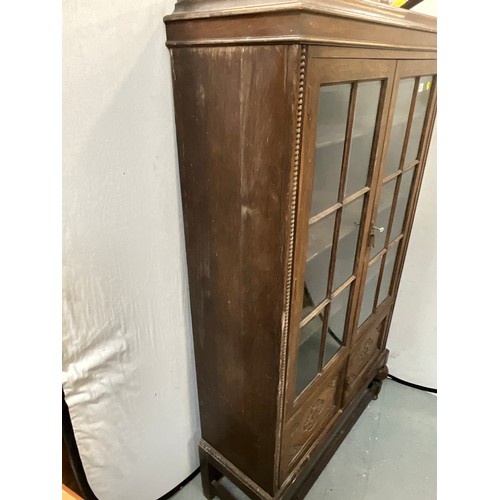 413 - VINTAGE OAK 2 DOOR GLAZED BOOKCASE WITH CARVED PANELS H73” W39” D16”