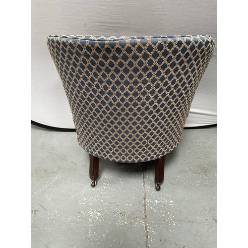 437 - EDWARDIAN UPHOLSTERED TUB CHAIR ON TURNED MAHOGANY LEGS WITH ORIGINAL CHINA CASTORS