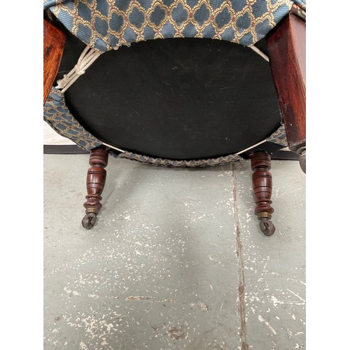 437 - EDWARDIAN UPHOLSTERED TUB CHAIR ON TURNED MAHOGANY LEGS WITH ORIGINAL CHINA CASTORS