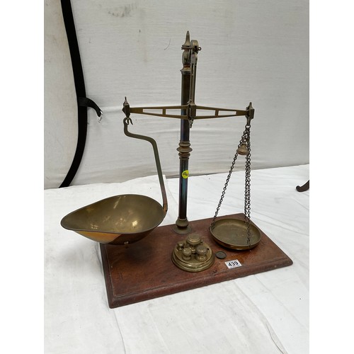 439 - VICTORIAN BRASS BALANCE SCALES COMPLETE WITH WEIGHTS AND TRAYS MOUNTED ON A MAHOGANY PLINTH 
H23” W2... 