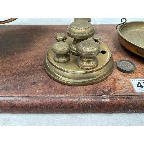 439 - VICTORIAN BRASS BALANCE SCALES COMPLETE WITH WEIGHTS AND TRAYS MOUNTED ON A MAHOGANY PLINTH 
H23” W2... 