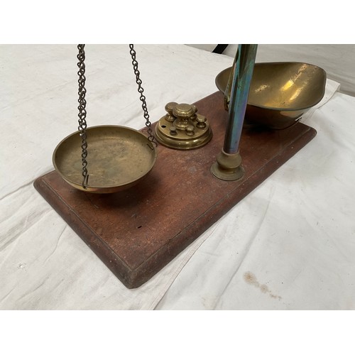 439 - VICTORIAN BRASS BALANCE SCALES COMPLETE WITH WEIGHTS AND TRAYS MOUNTED ON A MAHOGANY PLINTH 
H23” W2... 