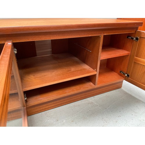 464 - BADGED NATHAN TEAK CORNER TV STAND WITH CENTRAL GLASS DOOR FLANKED BY 2 DOORS  H20” W41” D20”