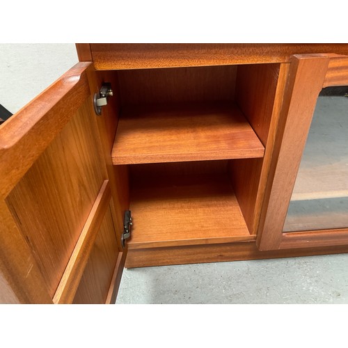 464 - BADGED NATHAN TEAK CORNER TV STAND WITH CENTRAL GLASS DOOR FLANKED BY 2 DOORS  H20” W41” D20”