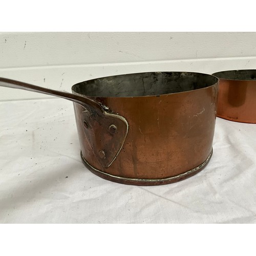 16 - A SET OF FIVE GRADUATED COPPER SAUCEPANS