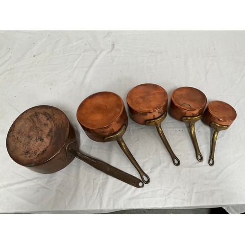 16 - A SET OF FIVE GRADUATED COPPER SAUCEPANS