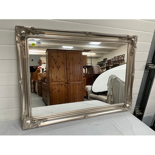 52 - A MODERN ORNATE FRAMED PLATE GLASS WALL MIRROR. 41