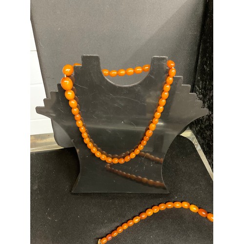 81 - TWO AMBER NECKLACES AND A PAIR OF EARINGS A/F TOTAL WEIGHT 45.2G