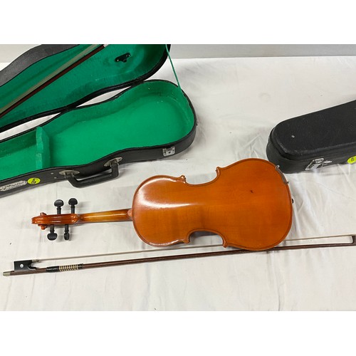 150 - TWO CASED VIOLINS AND SPARE BOW