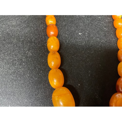 81 - TWO AMBER NECKLACES AND A PAIR OF EARINGS A/F TOTAL WEIGHT 45.2G