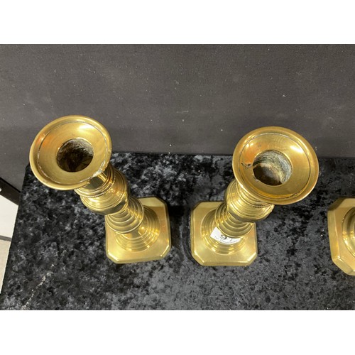 91 - TWO PAIRS OF ANTIQUE BRASS CANDLESTICKS WITH PUSHERS