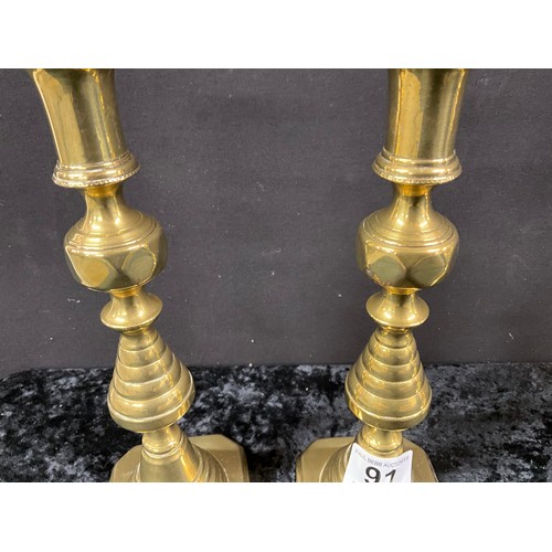 91 - TWO PAIRS OF ANTIQUE BRASS CANDLESTICKS WITH PUSHERS