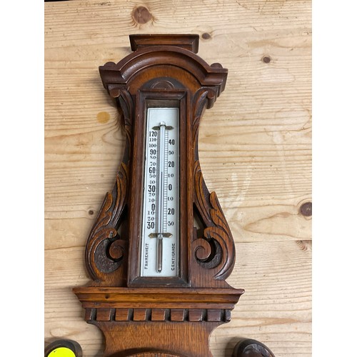 353A - EDWARDIAN BAROMETER IN A CARVED OAK CASE H24