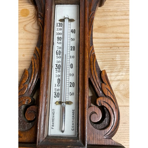 353A - EDWARDIAN BAROMETER IN A CARVED OAK CASE H24