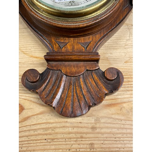 353A - EDWARDIAN BAROMETER IN A CARVED OAK CASE H24