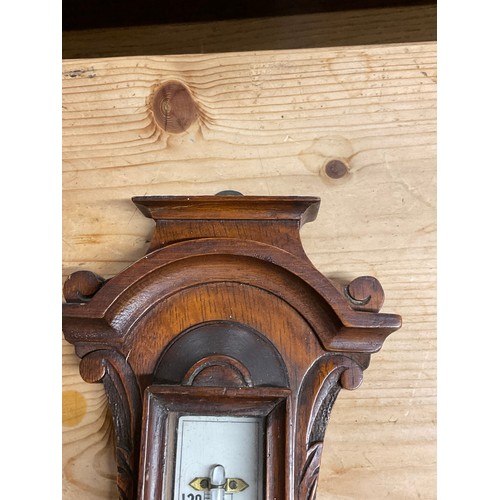 353A - EDWARDIAN BAROMETER IN A CARVED OAK CASE H24