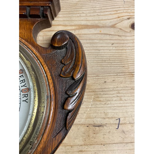 353A - EDWARDIAN BAROMETER IN A CARVED OAK CASE H24