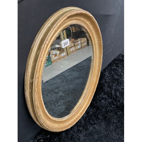 241 - OVAL BEVELLED EDGE MIRROR IN GILT WOODEN FRAME 24