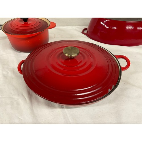 288 - BOX OF CAST IRON COOKWARE TO INCLUDE RED CASSEROLE DISH LE CREUSET SAUCEPAN WITH LID AND TWO OTHER L... 