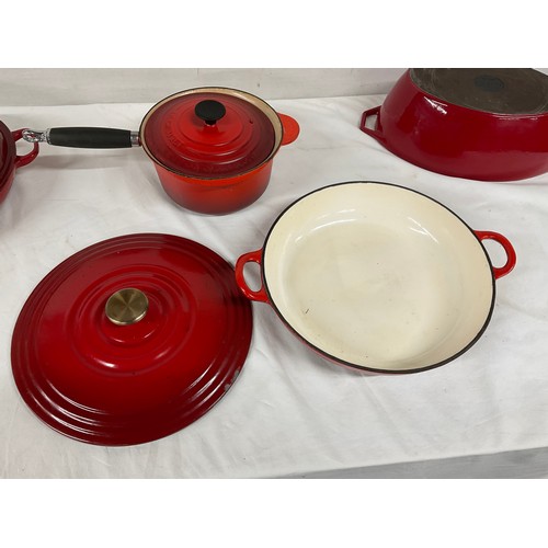 288 - BOX OF CAST IRON COOKWARE TO INCLUDE RED CASSEROLE DISH LE CREUSET SAUCEPAN WITH LID AND TWO OTHER L... 