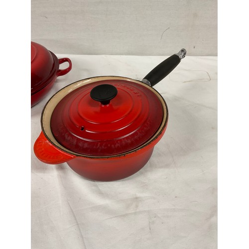 288 - BOX OF CAST IRON COOKWARE TO INCLUDE RED CASSEROLE DISH LE CREUSET SAUCEPAN WITH LID AND TWO OTHER L... 