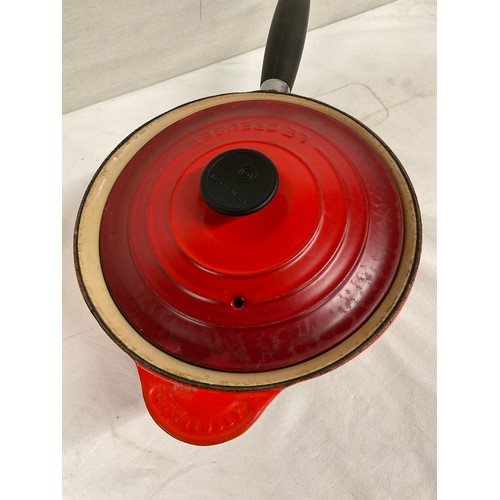 288 - BOX OF CAST IRON COOKWARE TO INCLUDE RED CASSEROLE DISH LE CREUSET SAUCEPAN WITH LID AND TWO OTHER L... 