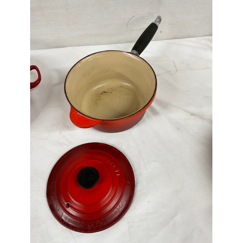 288 - BOX OF CAST IRON COOKWARE TO INCLUDE RED CASSEROLE DISH LE CREUSET SAUCEPAN WITH LID AND TWO OTHER L... 