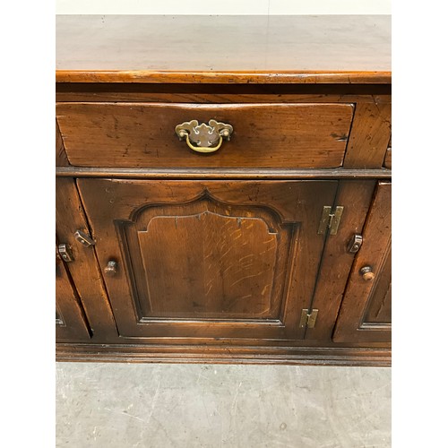 506 - LARGE REPRODUCTION OAK DRESSER BASE WITH THREE PANEL DOORS UNDER THREE DRAWERS W66