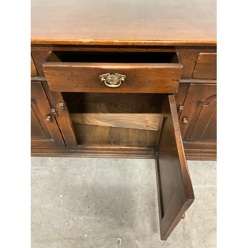 506 - LARGE REPRODUCTION OAK DRESSER BASE WITH THREE PANEL DOORS UNDER THREE DRAWERS W66