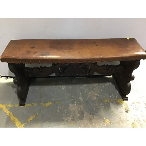 542 - ANTIQUE CARVED OAK BENCH WITH UPHOLSTERED LEATHER TOP AND ORNATE CARVING TO BASE W50