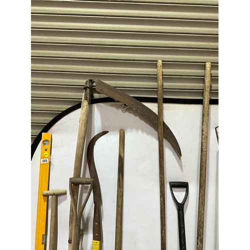 366 - QUANTITY OF GARDEN TOOLS TO INCLUDE VINTAGE SPADES SCYTHE TREE SAW ETC