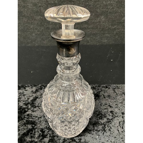 94 - FOUR CUT GLASS DECANTERS ONE WITH SILVER TOP