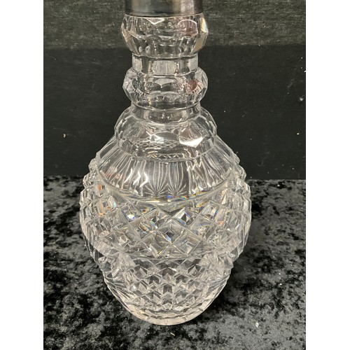 94 - FOUR CUT GLASS DECANTERS ONE WITH SILVER TOP