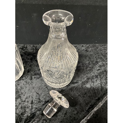 94 - FOUR CUT GLASS DECANTERS ONE WITH SILVER TOP