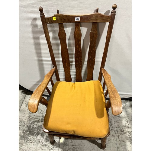 306 - LARGE OAK FRAMED ARM CHAIR WITH UPHOLSTERED CUSHION