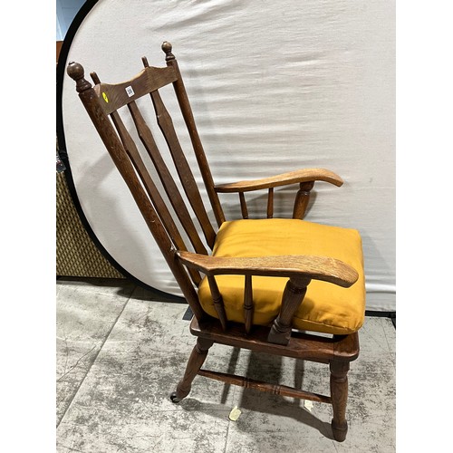 306 - LARGE OAK FRAMED ARM CHAIR WITH UPHOLSTERED CUSHION