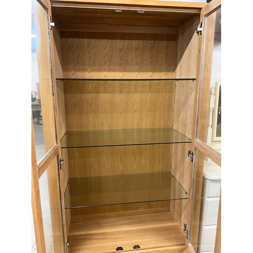 357 - MODERN TWO DOOR GLAZED OAK DISPLAY CABINET WITH TWO DRAWERS TO BASE W36