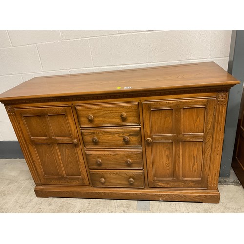 394 - VINTAGE BADGED ERCOL SIDE BOARD FOUR CENTRAL DRAWERS AND CUPBOARD TO EACH END W57