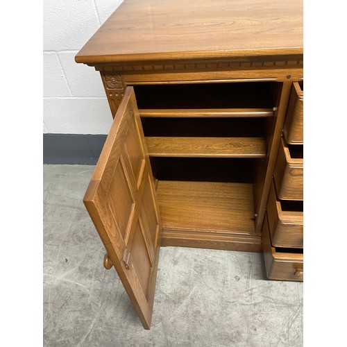 394 - VINTAGE BADGED ERCOL SIDE BOARD FOUR CENTRAL DRAWERS AND CUPBOARD TO EACH END W57