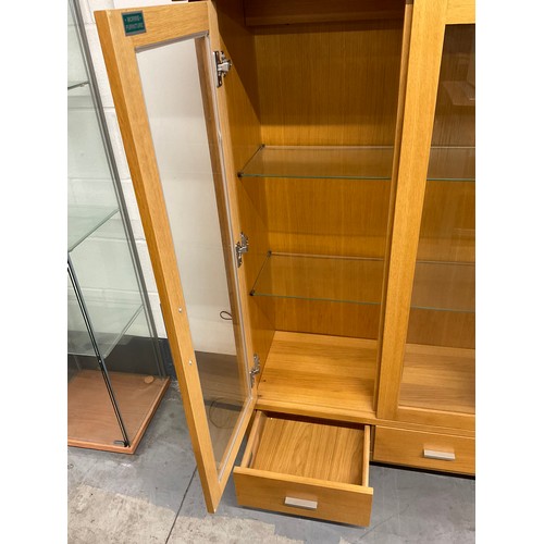 405 - MODERN GOLDEN OAK THREE DOOR GLAZED DISPLAY CABINET WITH THREE DRAWERS TO BASE W50