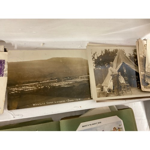 64 - POSTCARD ALBUM AND TIN OF POSTCARDS TO INCLUDE VARIOUS SUBJECTS TO INCLUDE THE WAR, SHIPS RAILWAY, V... 