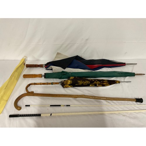 25 - QUANTITY OF UMBRELLAS, WALKING STICKS AND A TAPESTRY FRAME