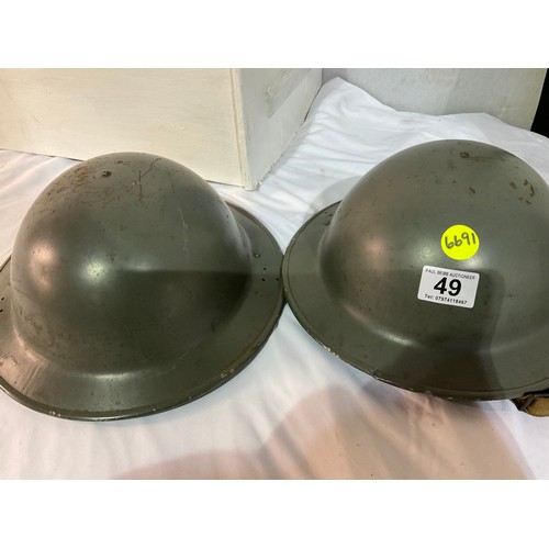 49 - TWO VINTAGE METAL MILITARY HELMETS