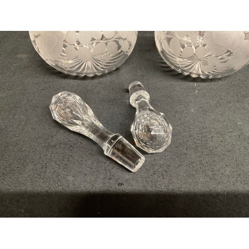 65 - A PAIR OF ETCHED GLASS DECANTERS DECORATED WITH FRUIT AND FOILLAGE