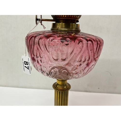 87 - VICTORIAN BRASS CORINTHAIN COLUMN OIL LAMP WITH RED GLASS BOWL AND SHADE COMPLETE WITH CHIMMNEY H26