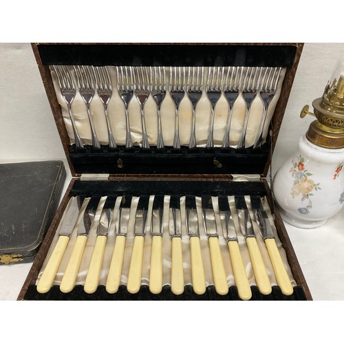 145 - BOX OF ODDS TO INCLUDE VICTROIAN OIL LAMPS, CASED CUTLERY ITEMS ETC