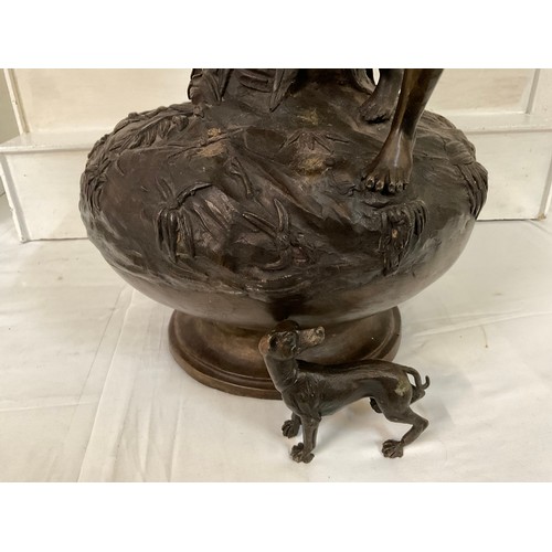 85 - SOLID HEAVY BRONZE VASE DECORATED WITH FOILAGE MAN AND HIS DOG (DOG IS LOOSE) H31”