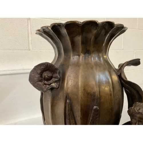 85 - SOLID HEAVY BRONZE VASE DECORATED WITH FOILAGE MAN AND HIS DOG (DOG IS LOOSE) H31”