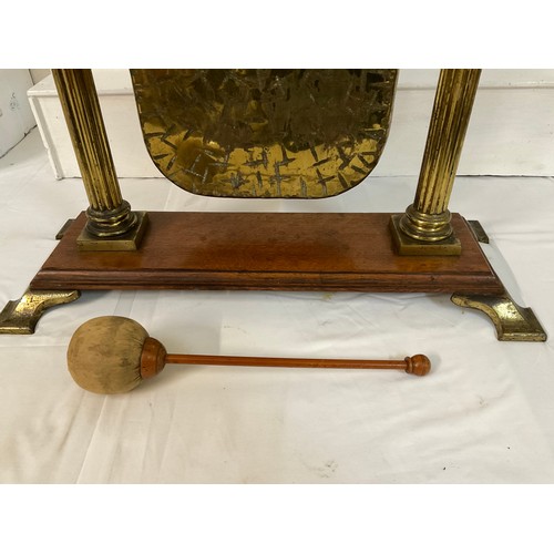 91 - VICTORIAN BRASS DINNER GONG WITH CORINTHIAN COLUMNS ON MAHOGANY BASE COMPLETE WITH HAMMER