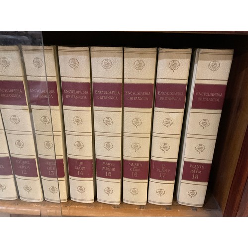 94 - SLIDING GLASS BOOKCASE AND COMPLETE SET OF 24 VOLUMES ENCYCLOPEDIA BRITANNICA H31” D11” W37.5”